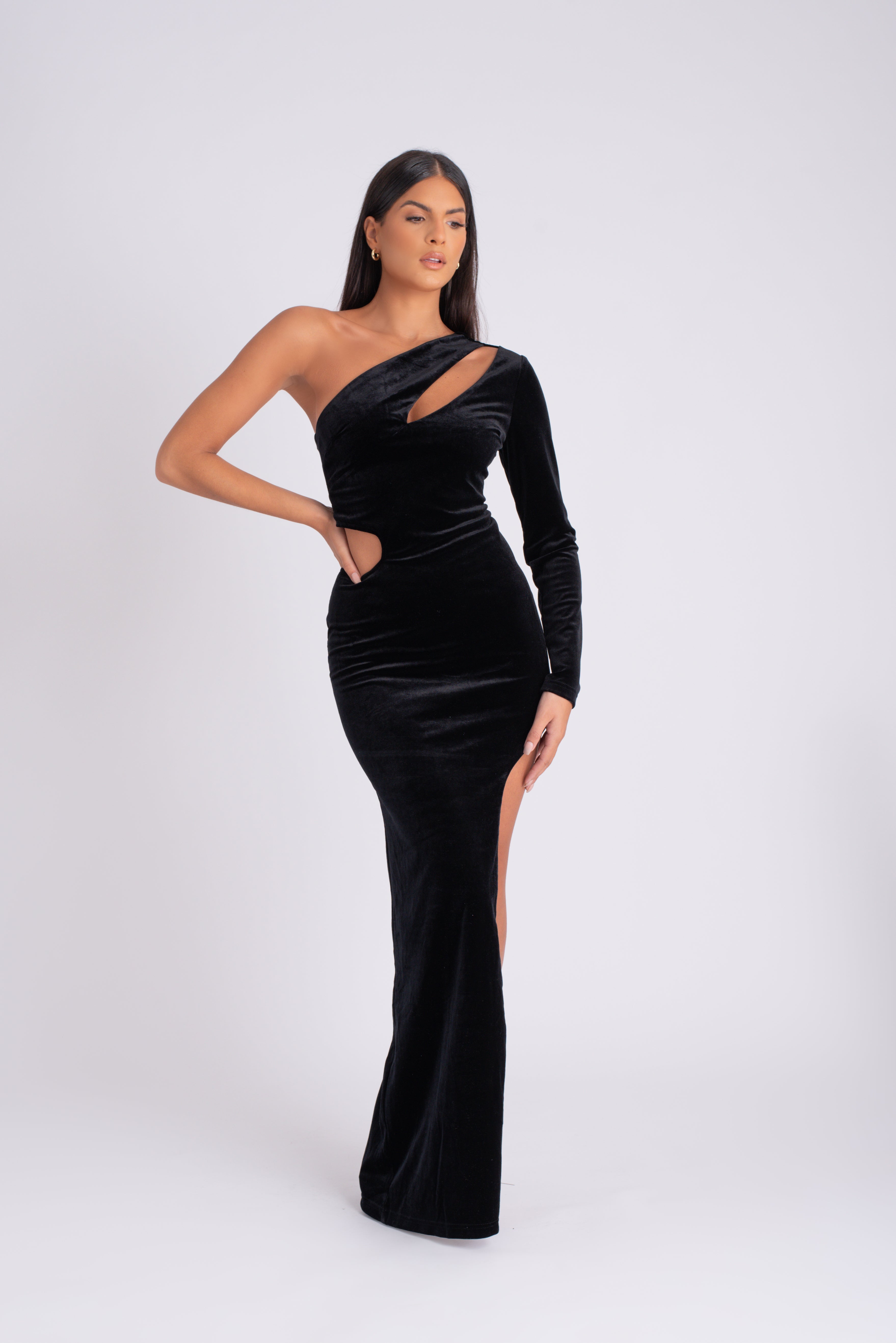 Womens velvet maxi gown with high slit with one shoulder front cut out dress in black by Olivia Reign True to Size Designed for a close fit Mid-weight, stretchy fabric Burgundy velvet Concealed zip fastening along back Front cut out Asymmetric neckline Maxi length Thigh slit One shoulder sleeve